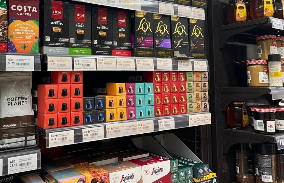 Mood Espresso capsule packs arranged by blend on a shop shelf